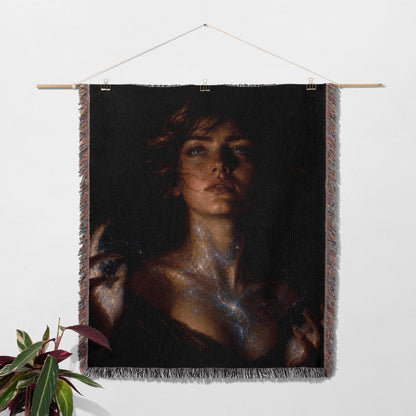 a large portrait of a woman hanging on a wall, with a potted plant to the left of the frame.