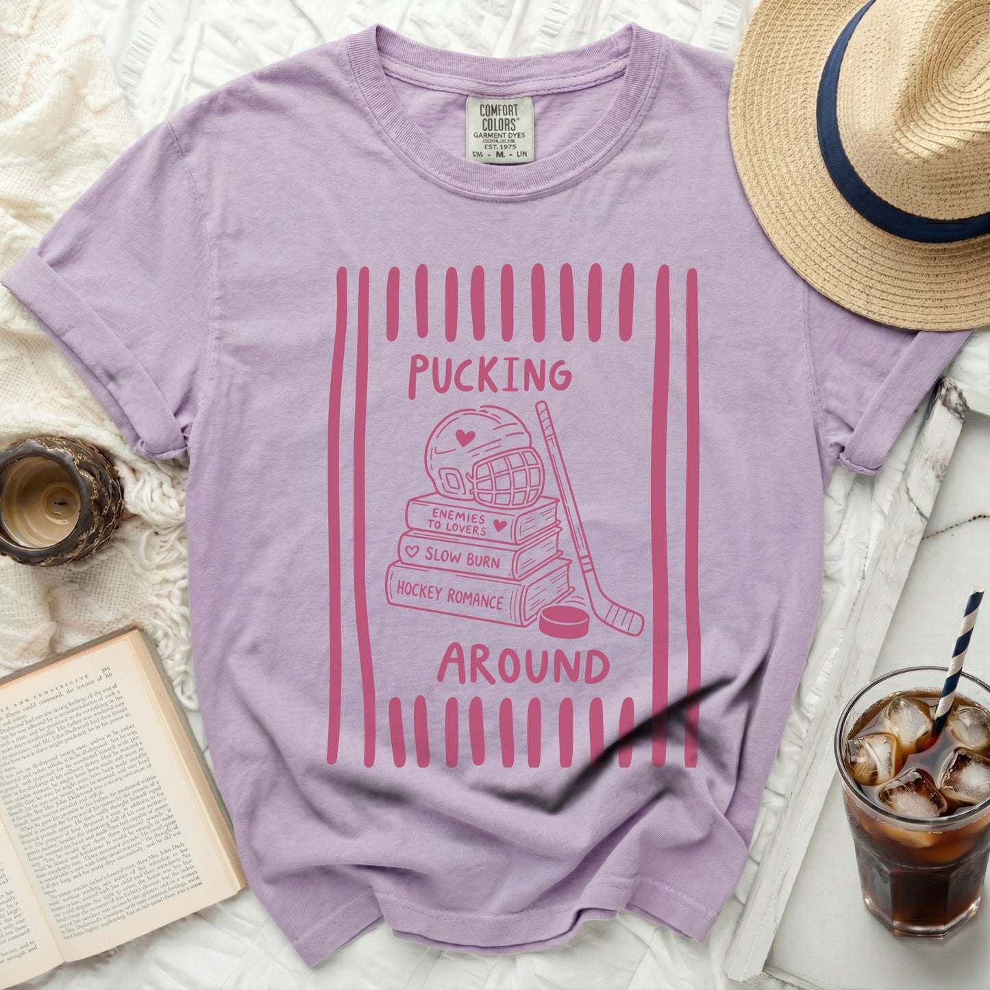 Purple t-shirt with "Pucking Around Hockey Romance" text and hockey graphic.