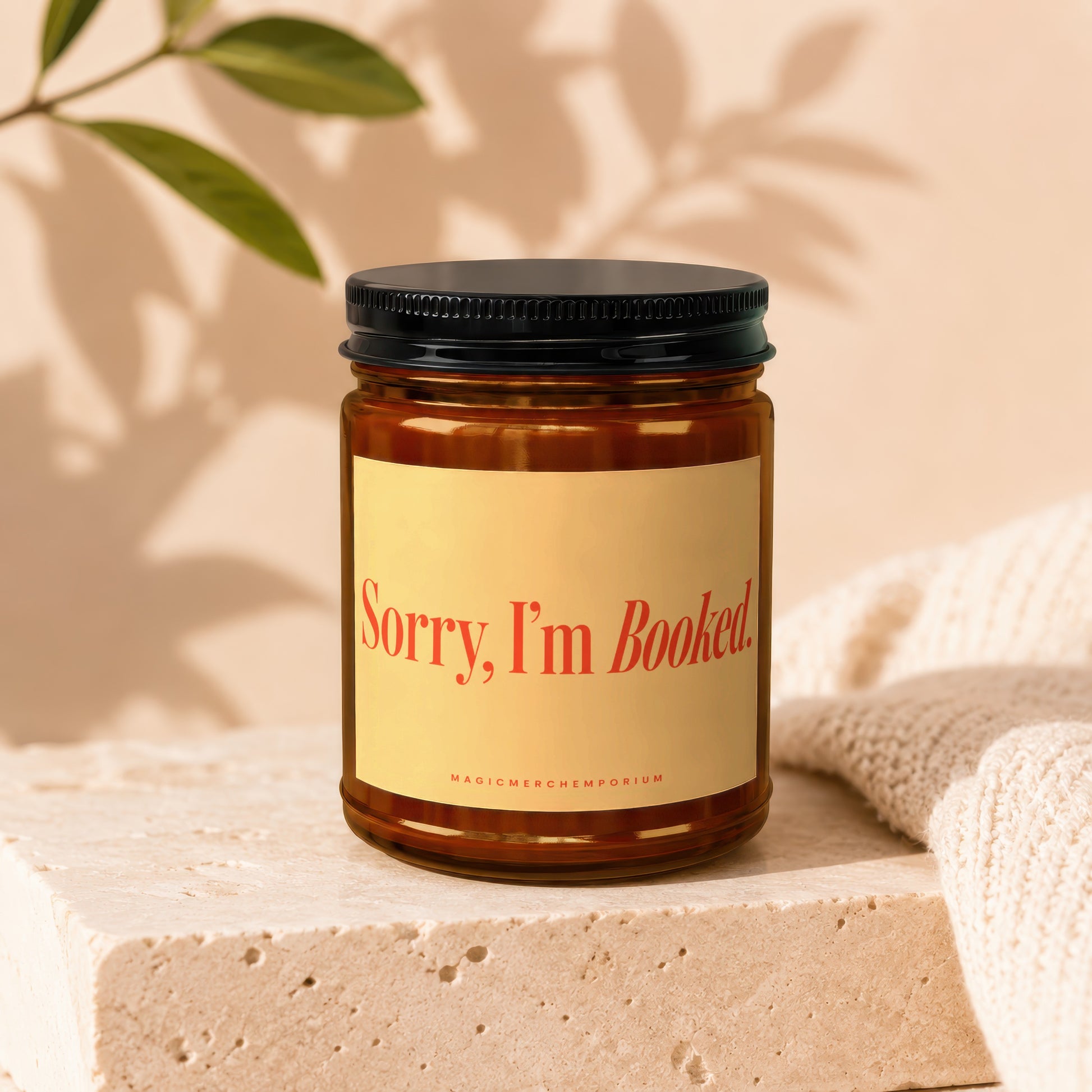 Amber jar candle with "Sorry, I'm Booked." text and "MAGICMERCH]EMPORIUM" logo.