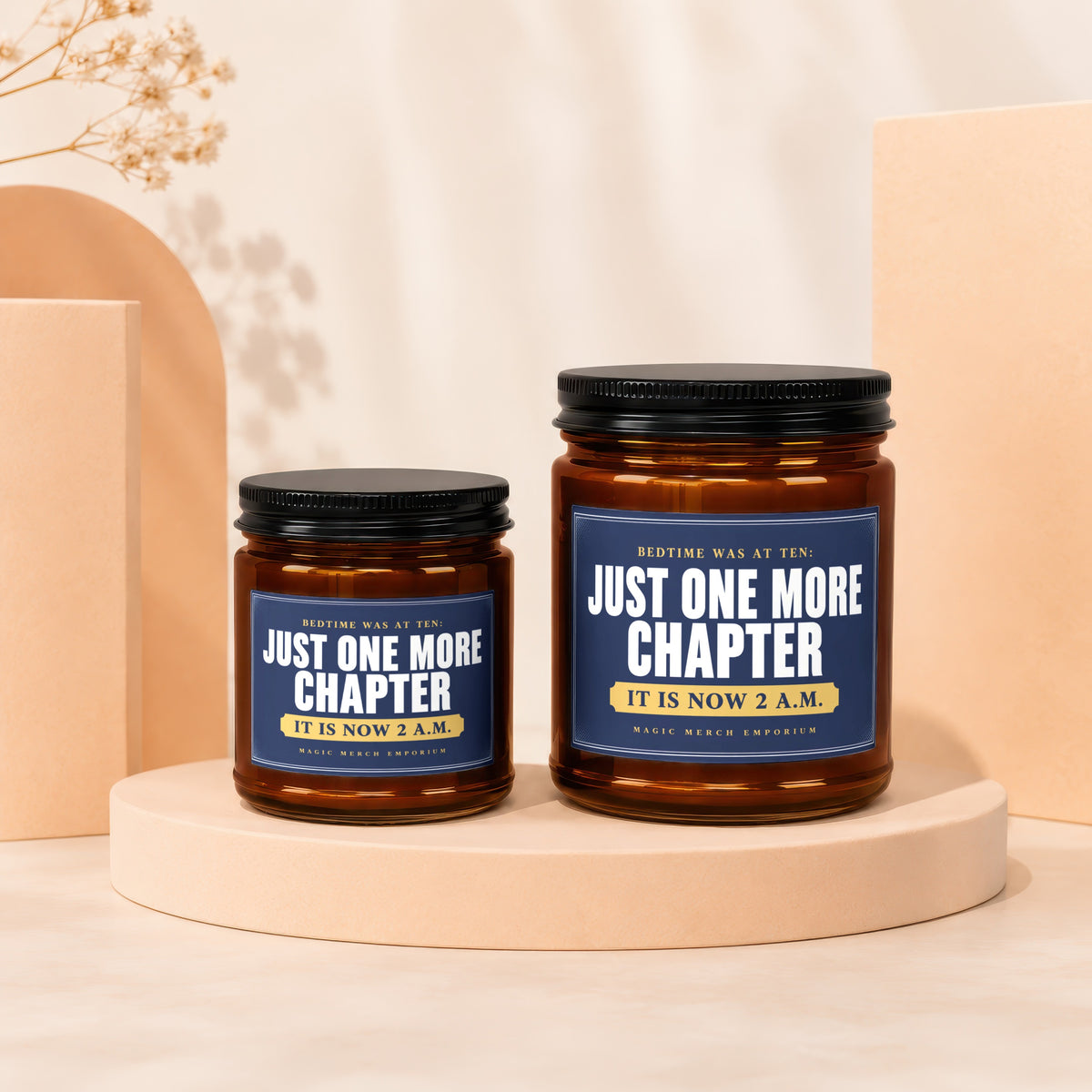 Two amber glass candles with dark lids, featuring labels about reading late.