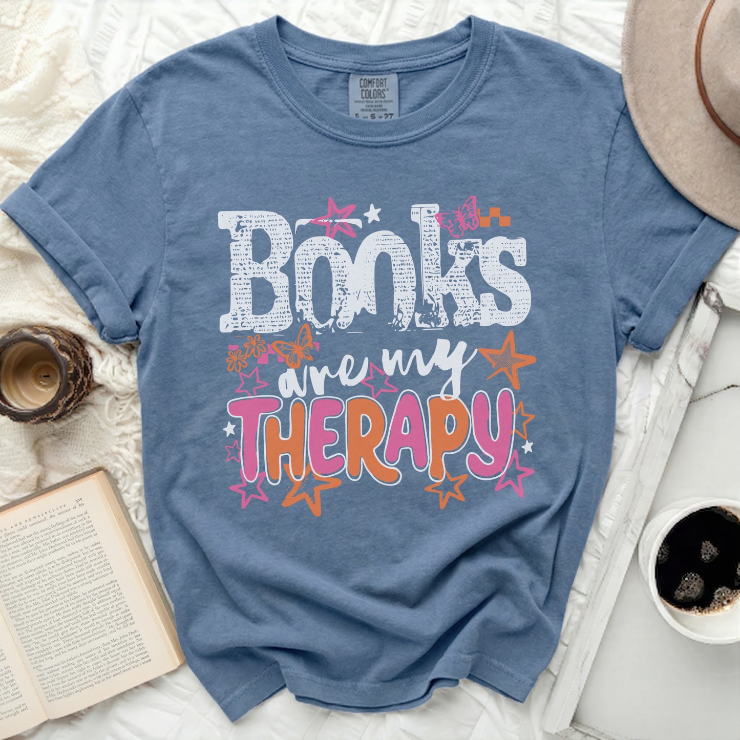 Blue t-shirt with "Books are my Therapy" graphic and butterflies.