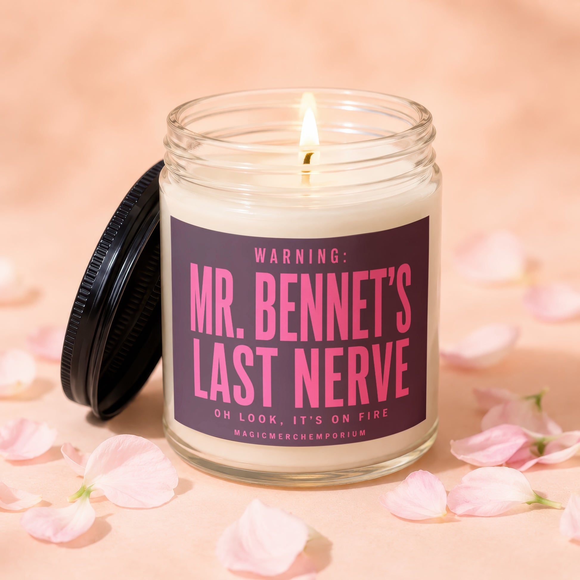Lit candle with "Mr. Bennet's Last Nerve" label surrounded by pink petals.