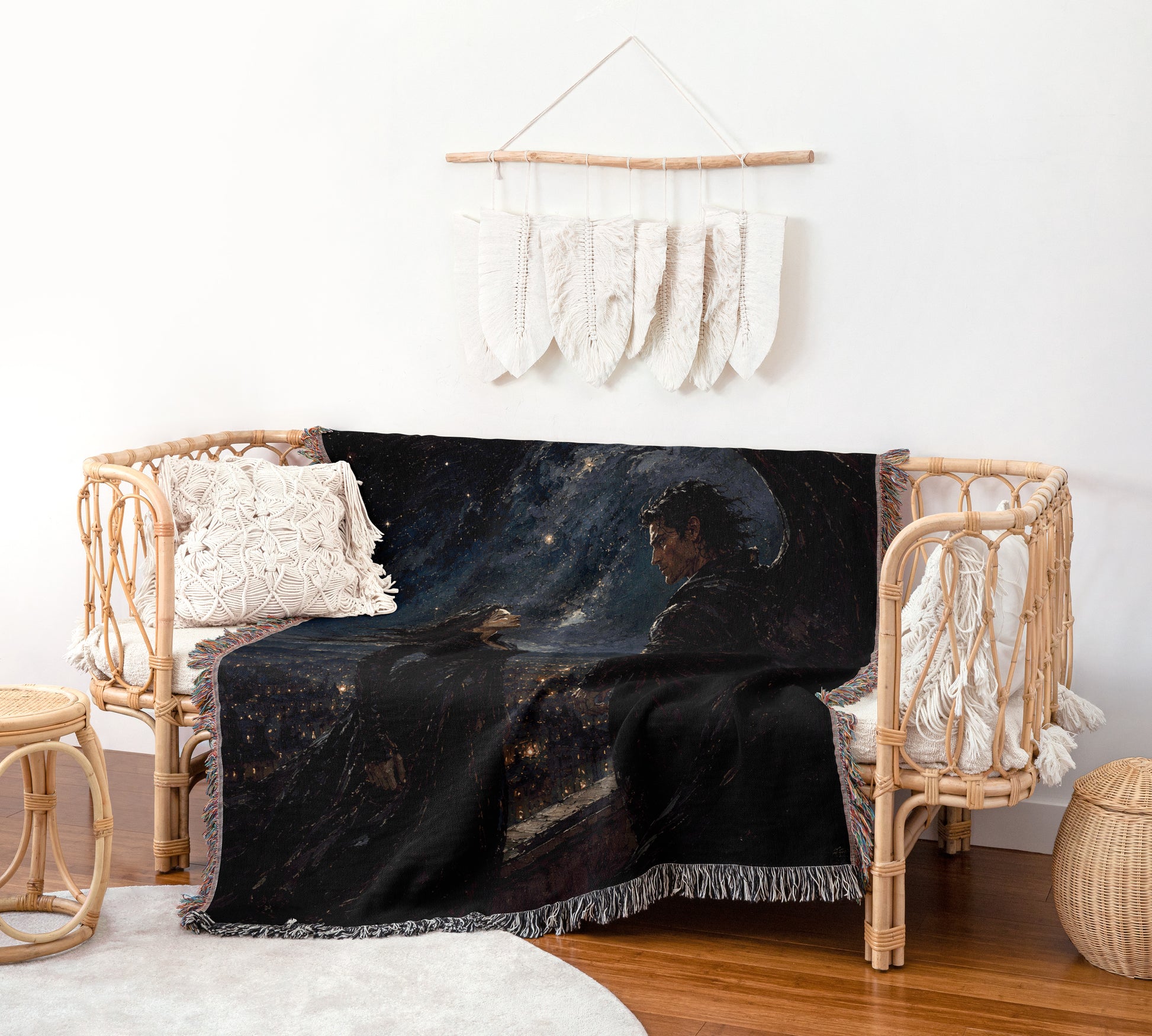 a cozy living room with a wicker chair, a woven basket, and a woven rug. The chair has a black blanket with a painting of a person on it. The wall behind the chair has a hanging decoration made of white feathers.