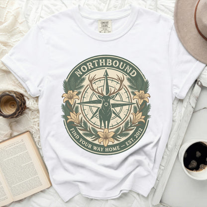 White t-shirt with compass, deer, flowers, and text: "Northbound Find Your Way Home Est. 2012"