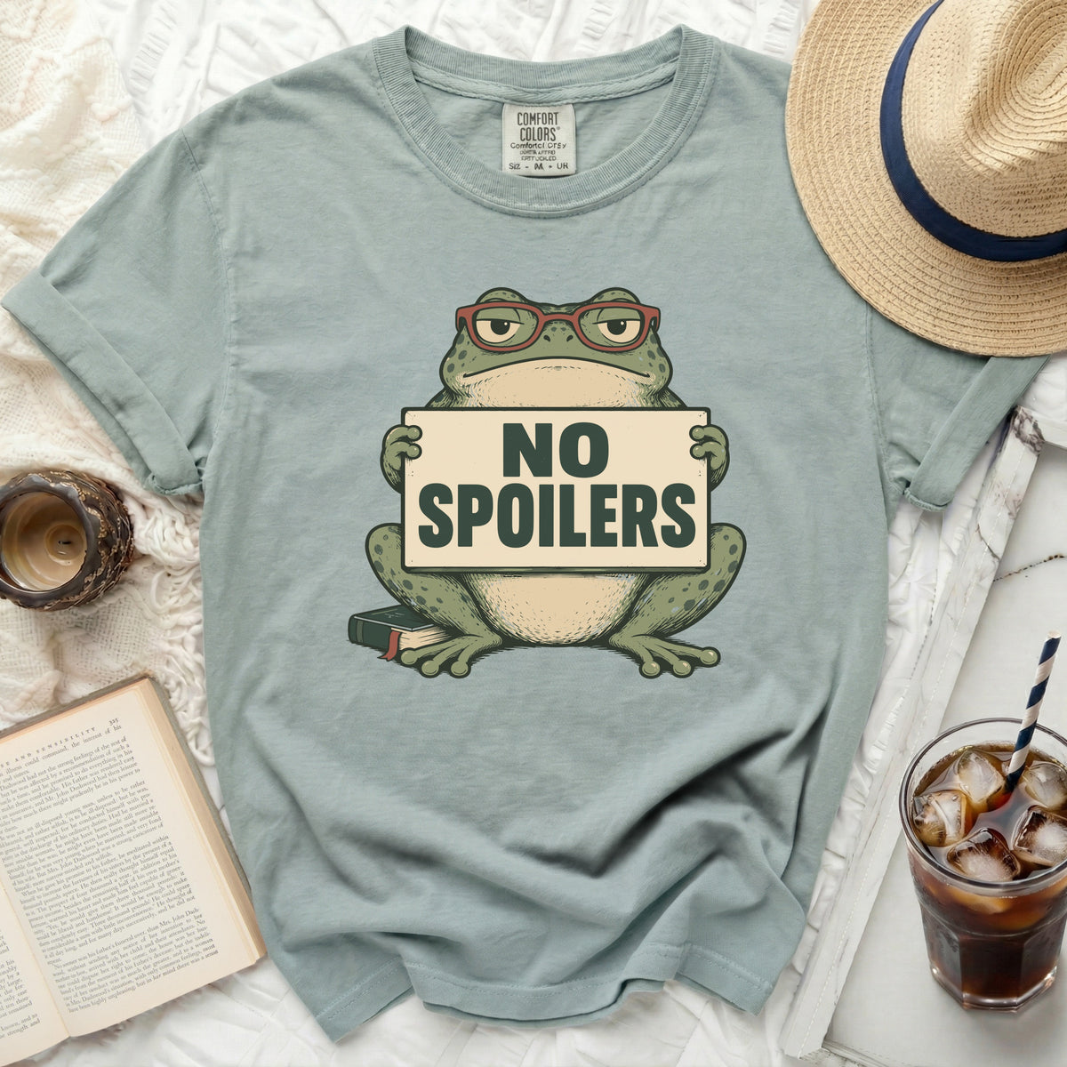 Green t-shirt with a frog wearing glasses holding a "NO SPOILERS" sign.