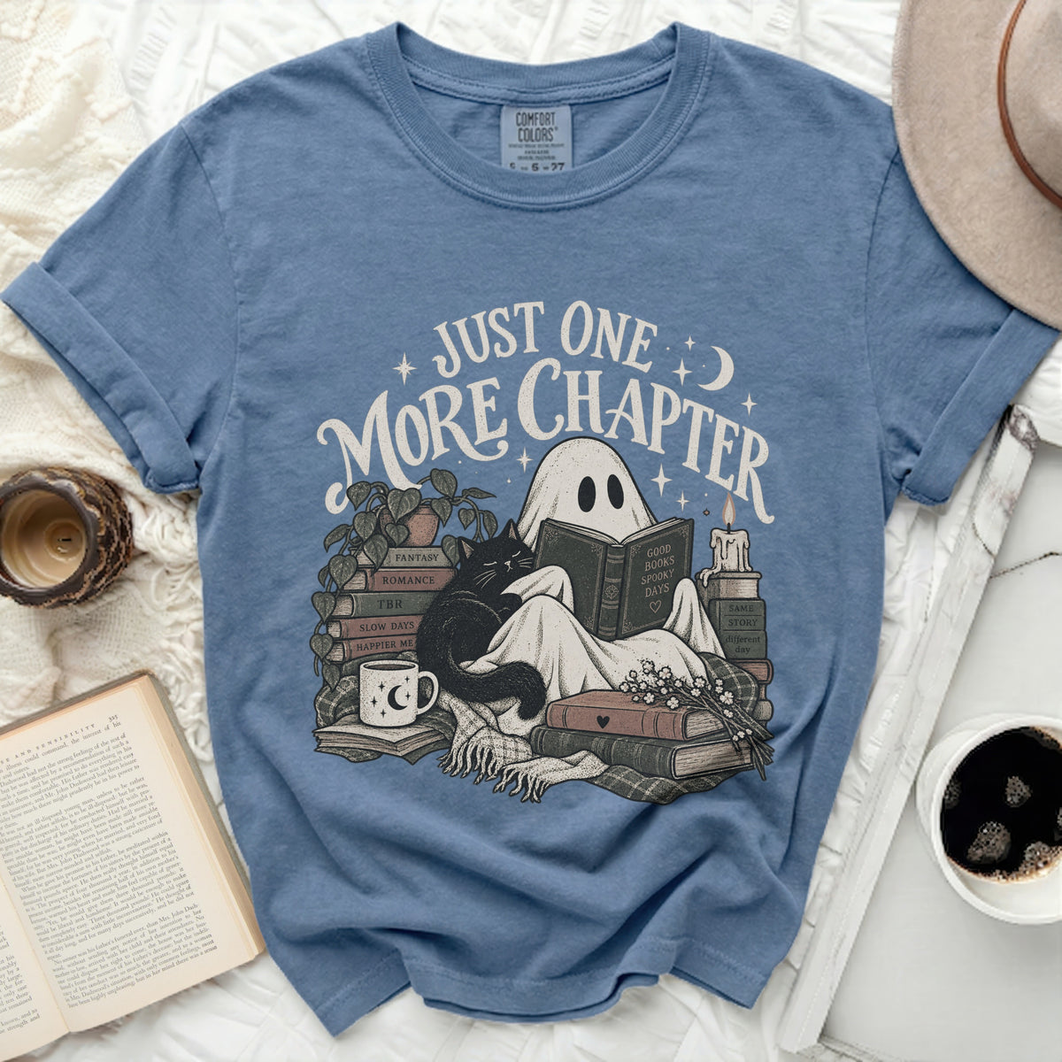 Ghost reading book with cat and text "Just One More Chapter".