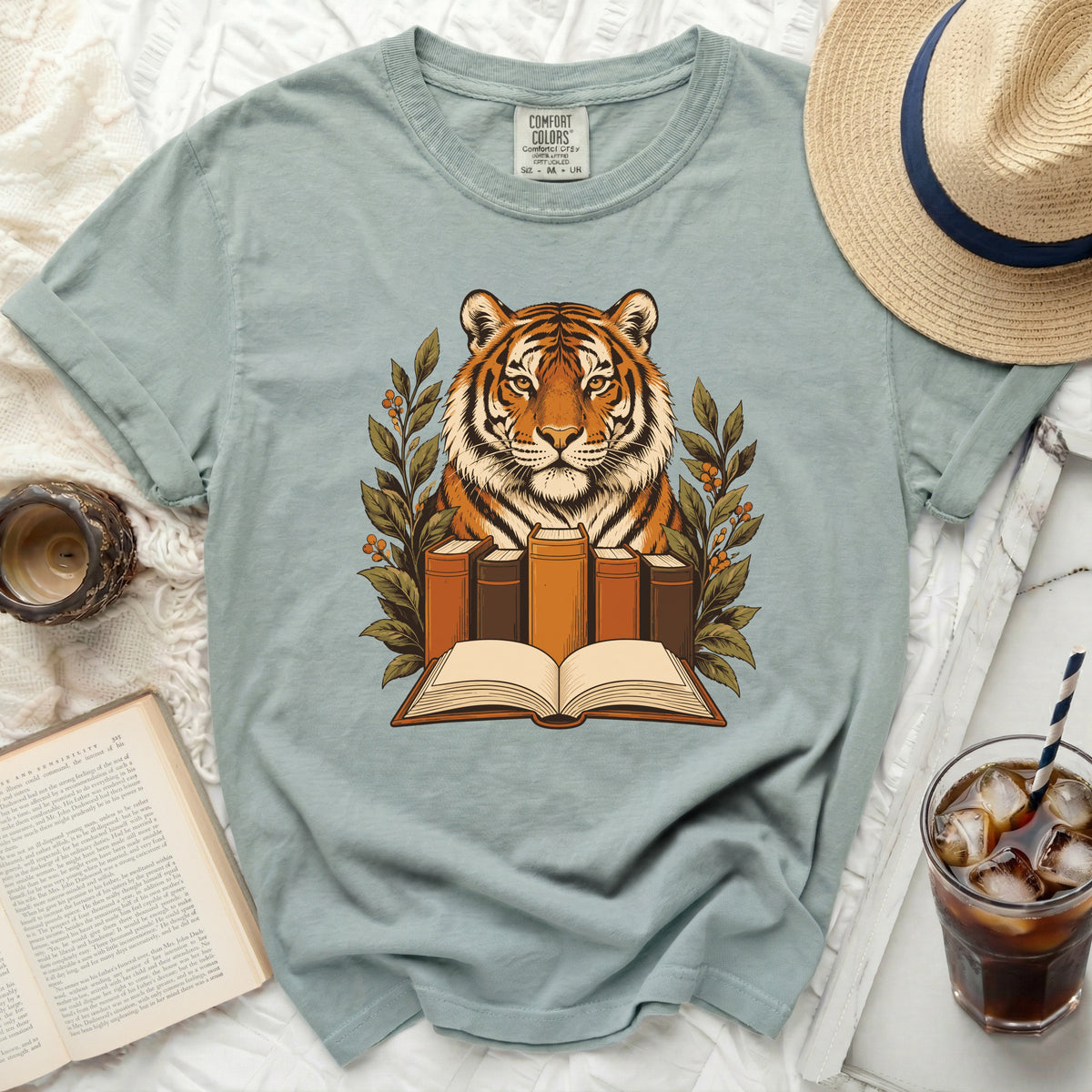Tiger with open book and surrounding foliage design on a t-shirt.