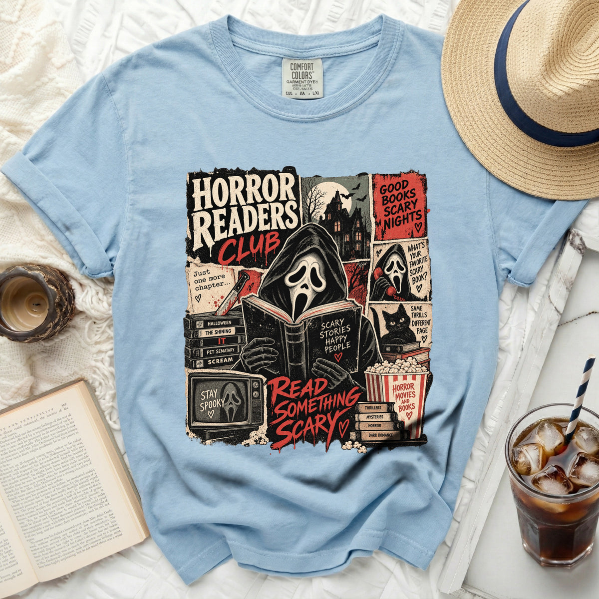 Light blue t-shirt with "Horror Readers Club" graphic of a masked figure reading.