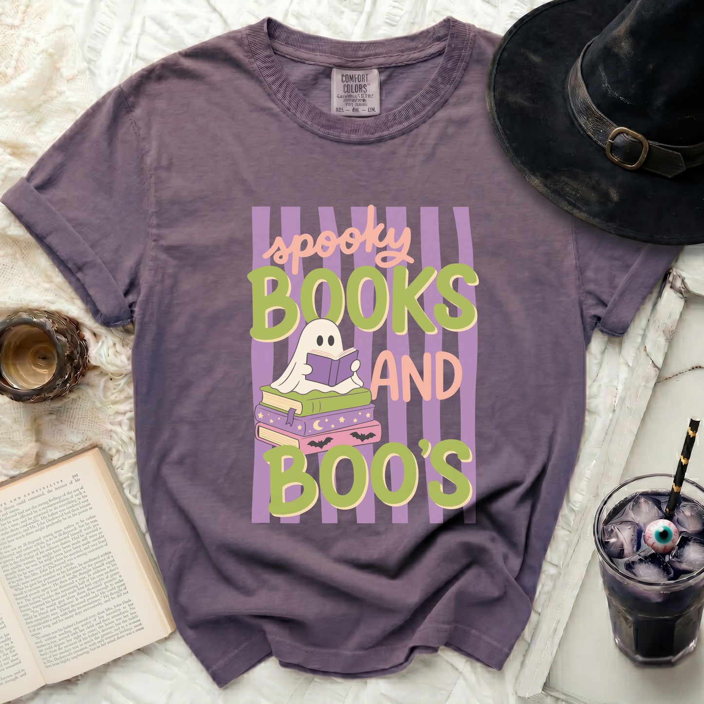 Purple t-shirt with "spooky books and boo's" Halloween graphic.