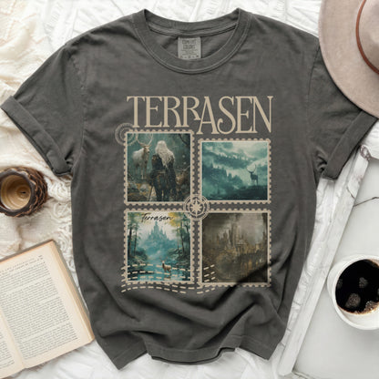 Dark gray t-shirt with four postage stamp-style scenes of fantasy landscapes.