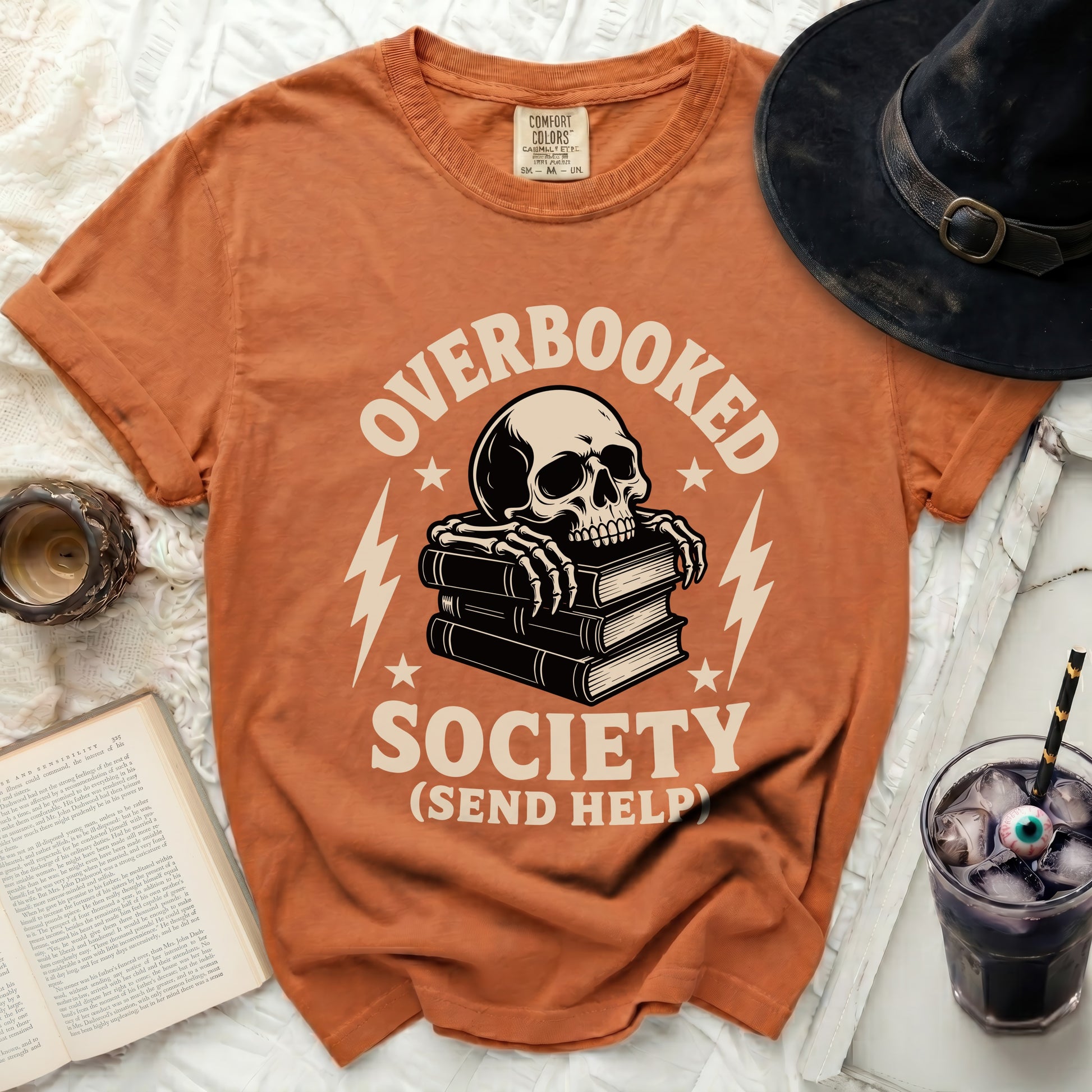 Orange t-shirt with skull on books, text "OVERBOOKED SOCIETY (SEND HELP)".