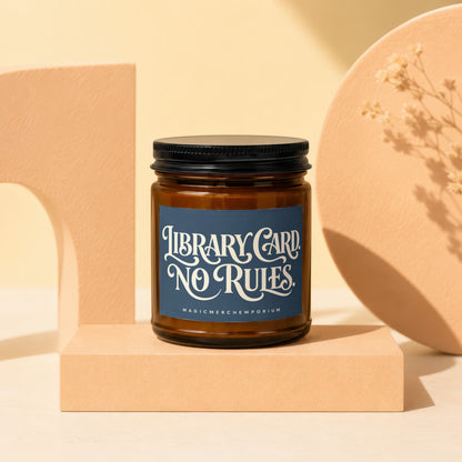 Amber jar candle with blue label that reads "LIBRARY CARD NO RULES".