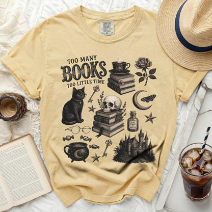 Yellow t-shirt with "Too Many Books Too Little Time" graphic and literary motifs.