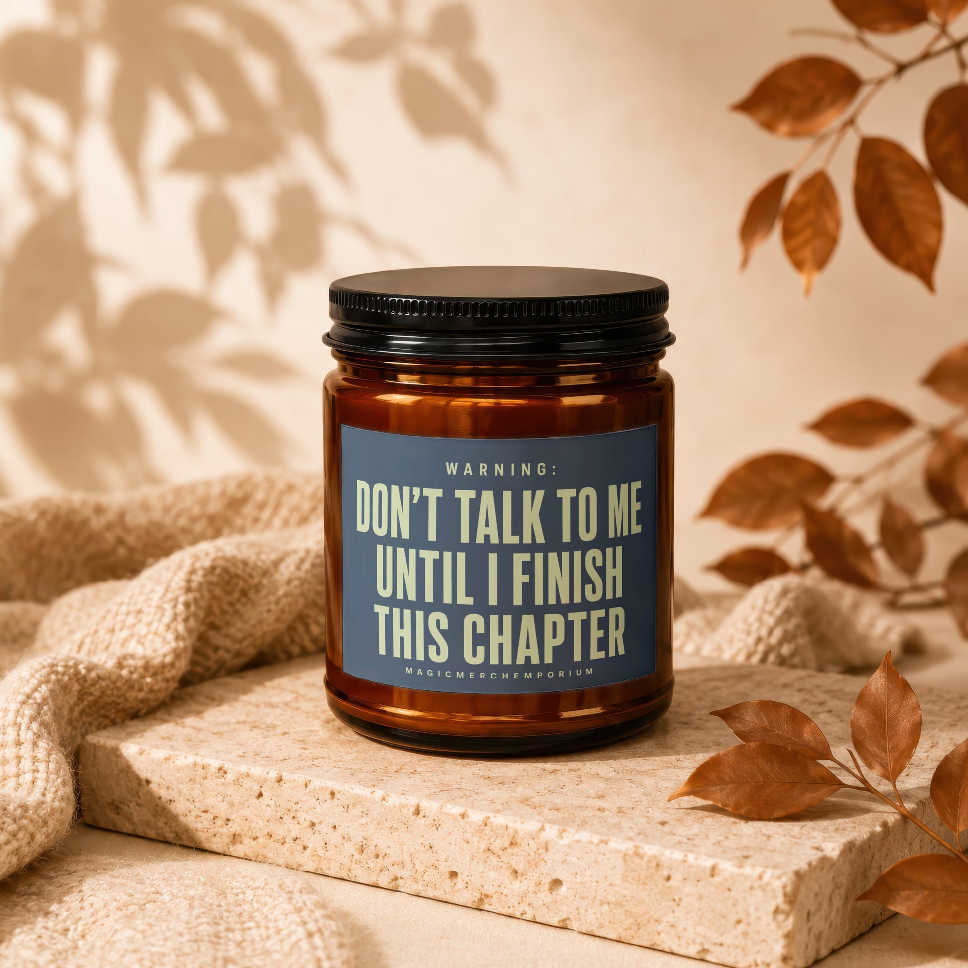 Amber candle with a black lid, reading "Don't talk to me until I finish this chapter".