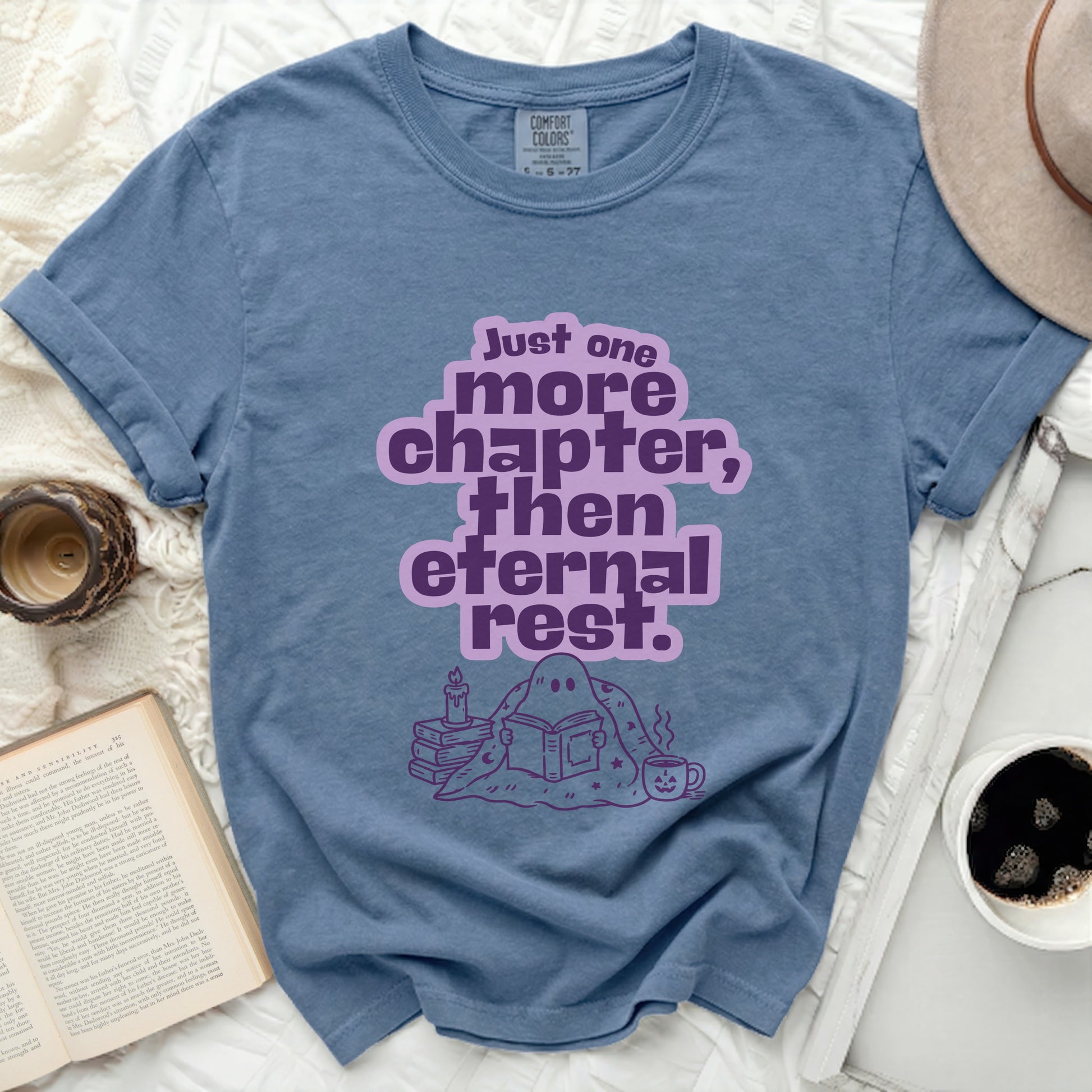 Blue t-shirt with "Just one more chapter, then eternal rest" graphic.