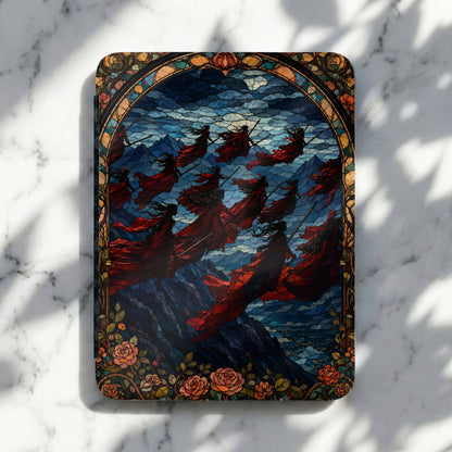Stained glass art of figures in red robes with spears against a mountainous, cloudy sky.