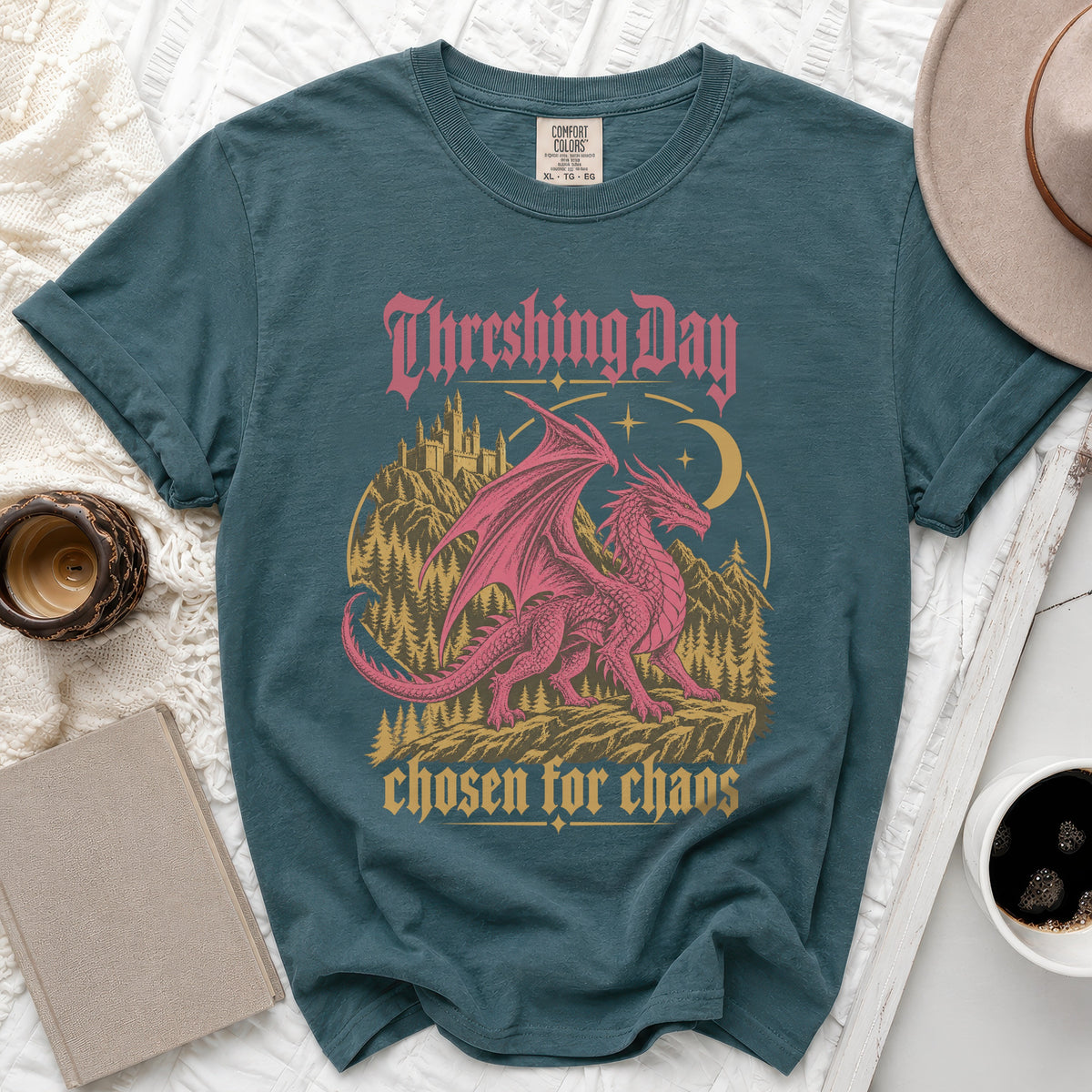 Teal t-shirt with pink dragon, castle, and text "Threshing Day chosen for chaos".