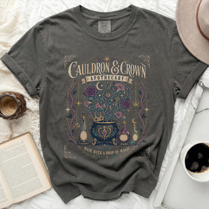 Gray t-shirt with "Cauldron & Crown Apothecary" and floral design.