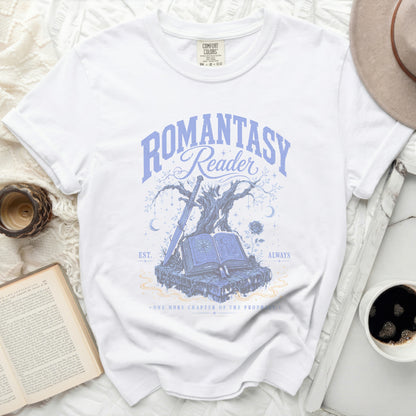 White t-shirt with "Romantasy Reader" and book, sword, and tree graphic.