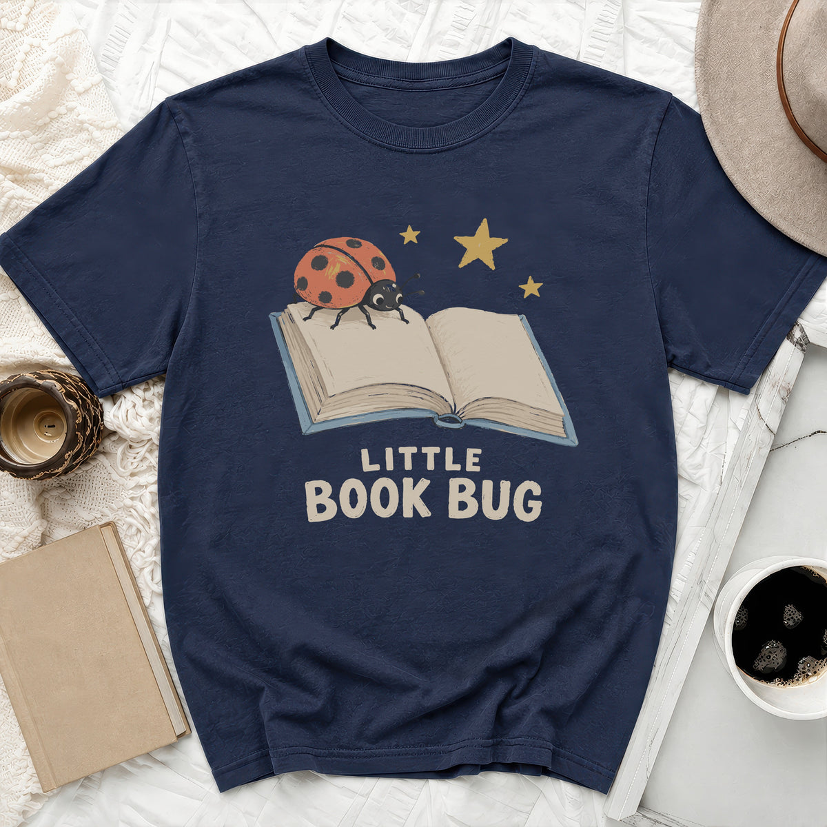 Navy t-shirt with ladybug on open book and text "LITTLE BOOK BUG".