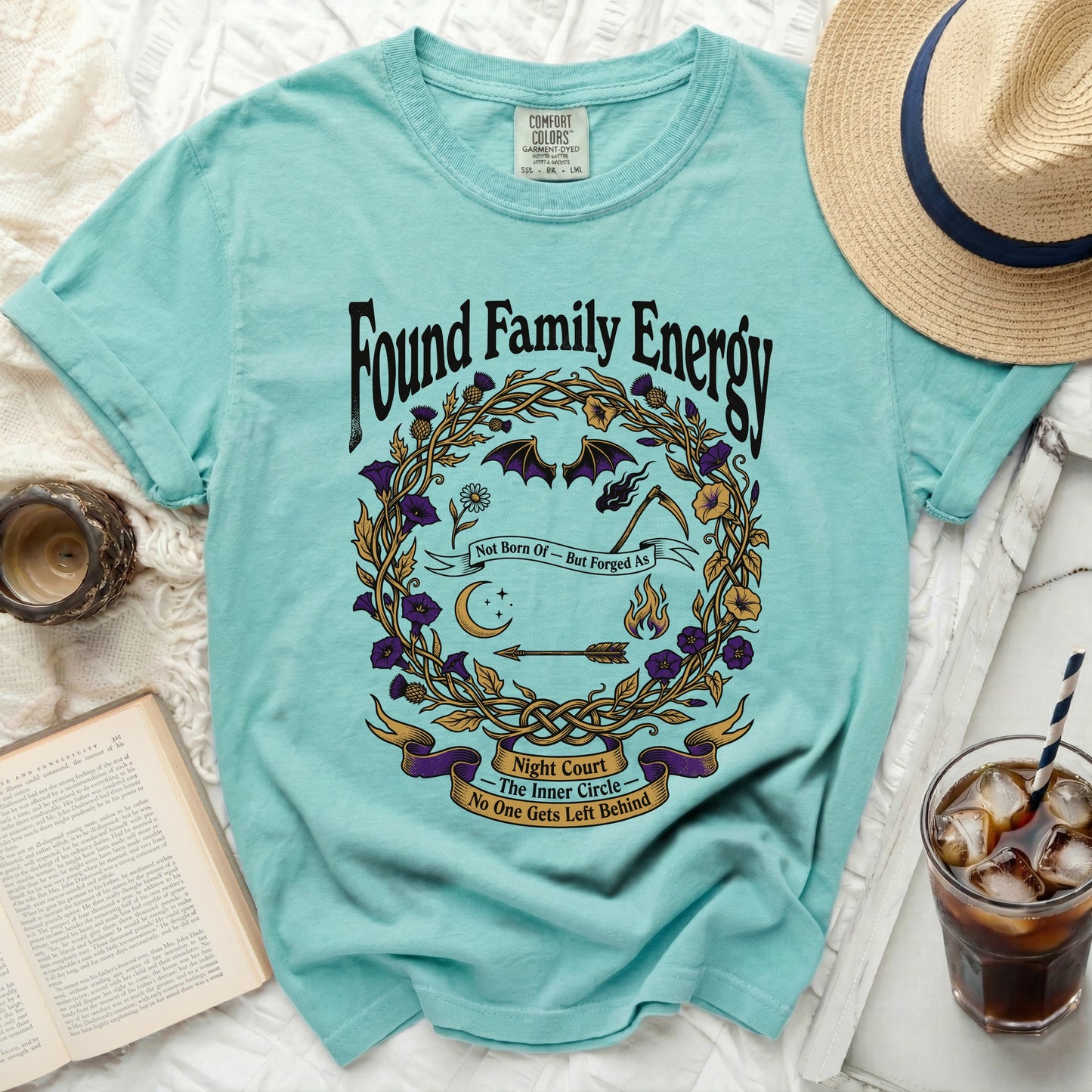 Teal t-shirt with "Found Family Energy" and witchy circular graphic.