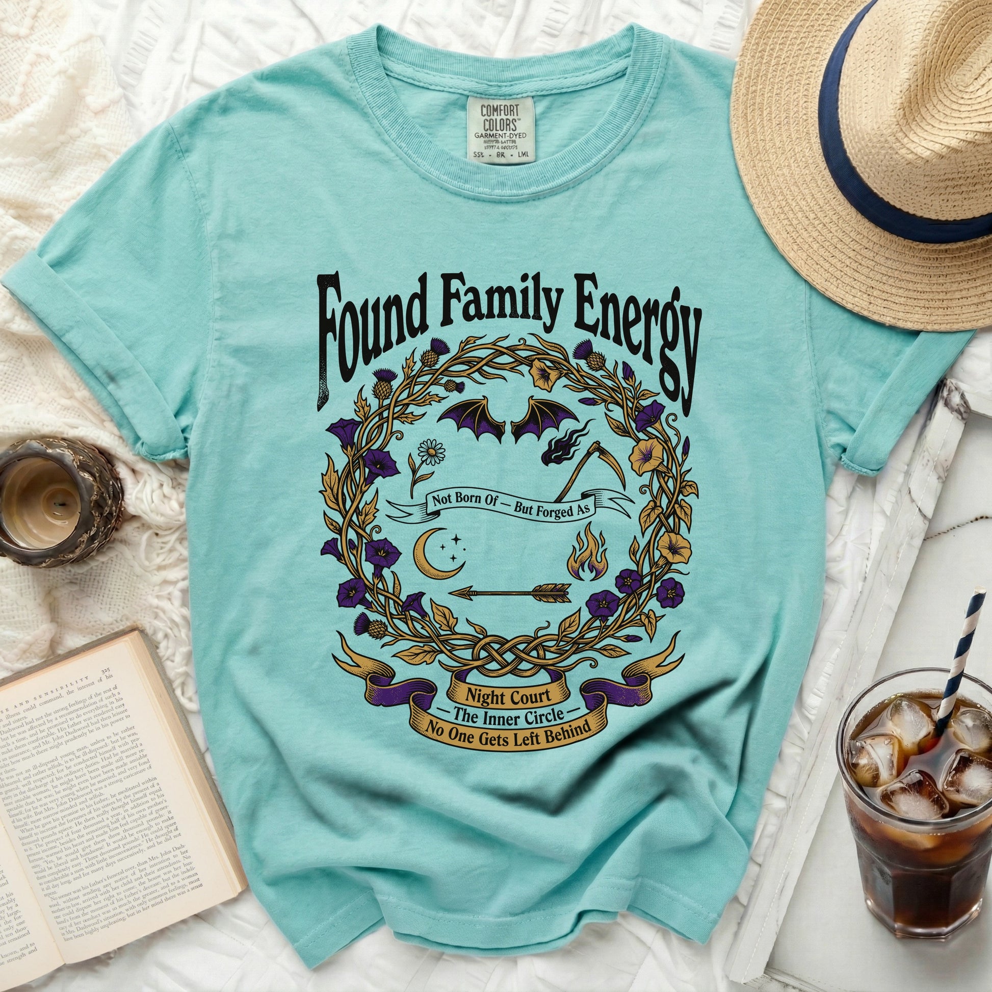 Teal t-shirt with "Found Family Energy" and witchy circular graphic.