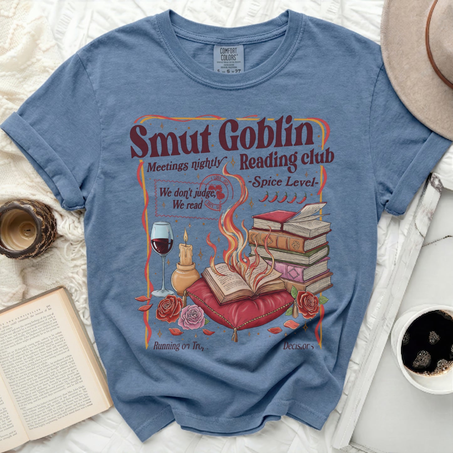 T-shirt with "Smut Goblin Reading Club" text and book/candle graphics.