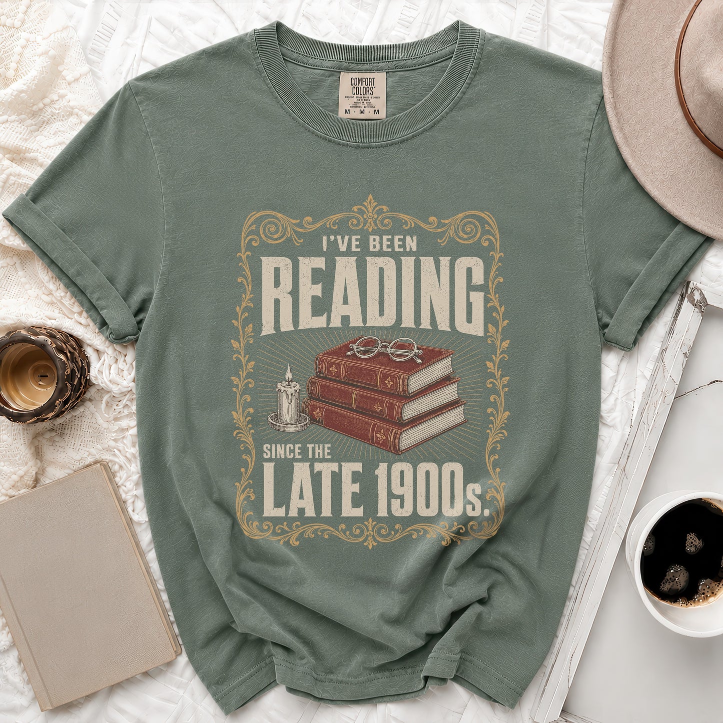 "I've Been Reading Since the Late 1900s" t-shirt with books, glasses, and candle graphic.