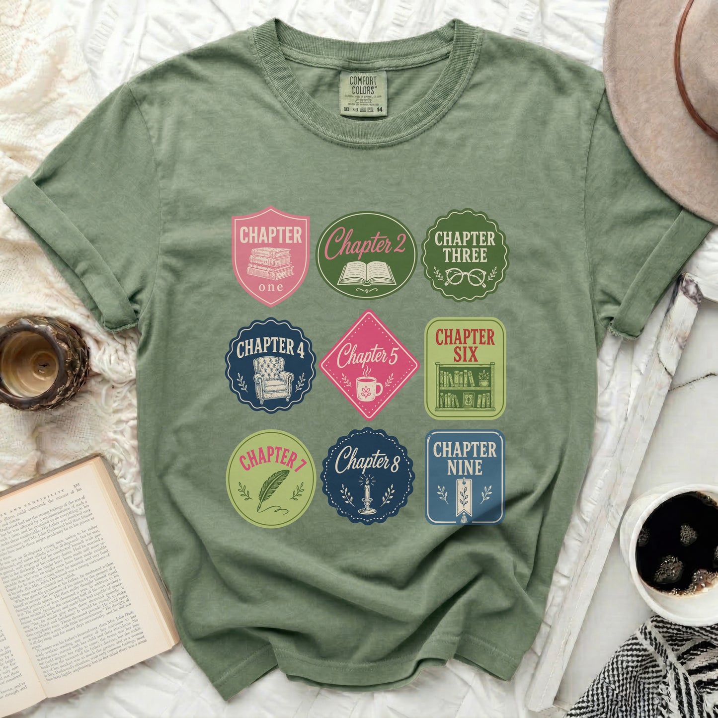 Green t-shirt with circular chapter badges featuring titles like "Chapter One" and "Chapter Nine".