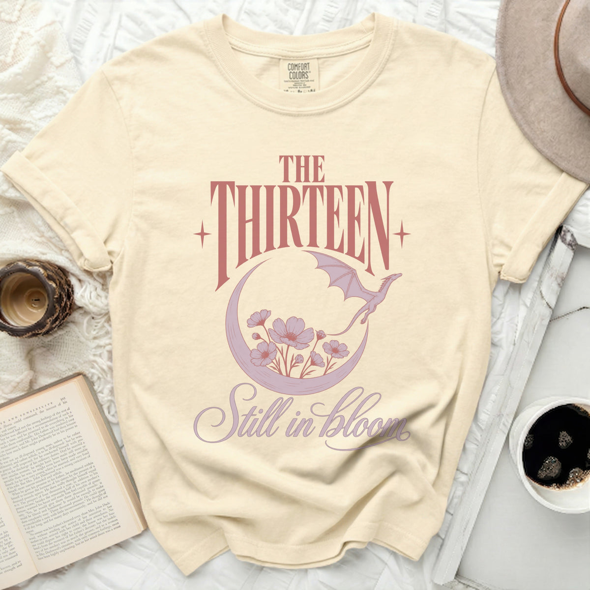 Cream t-shirt with "The Thirteen Still in Bloom" text and dragon graphic.