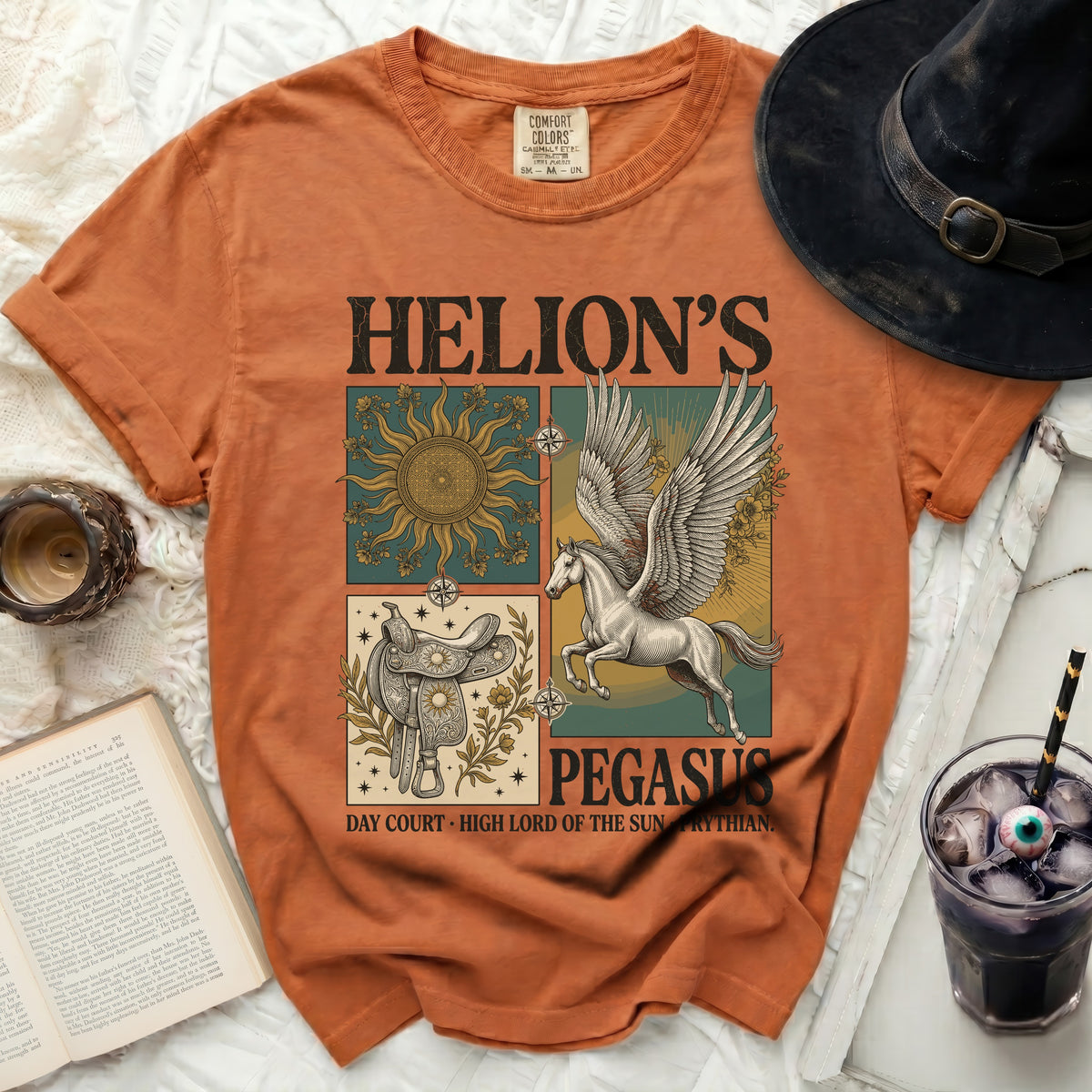 Orange t-shirt with "Helion's Pegasus" graphic, sun, saddle, and winged horse.