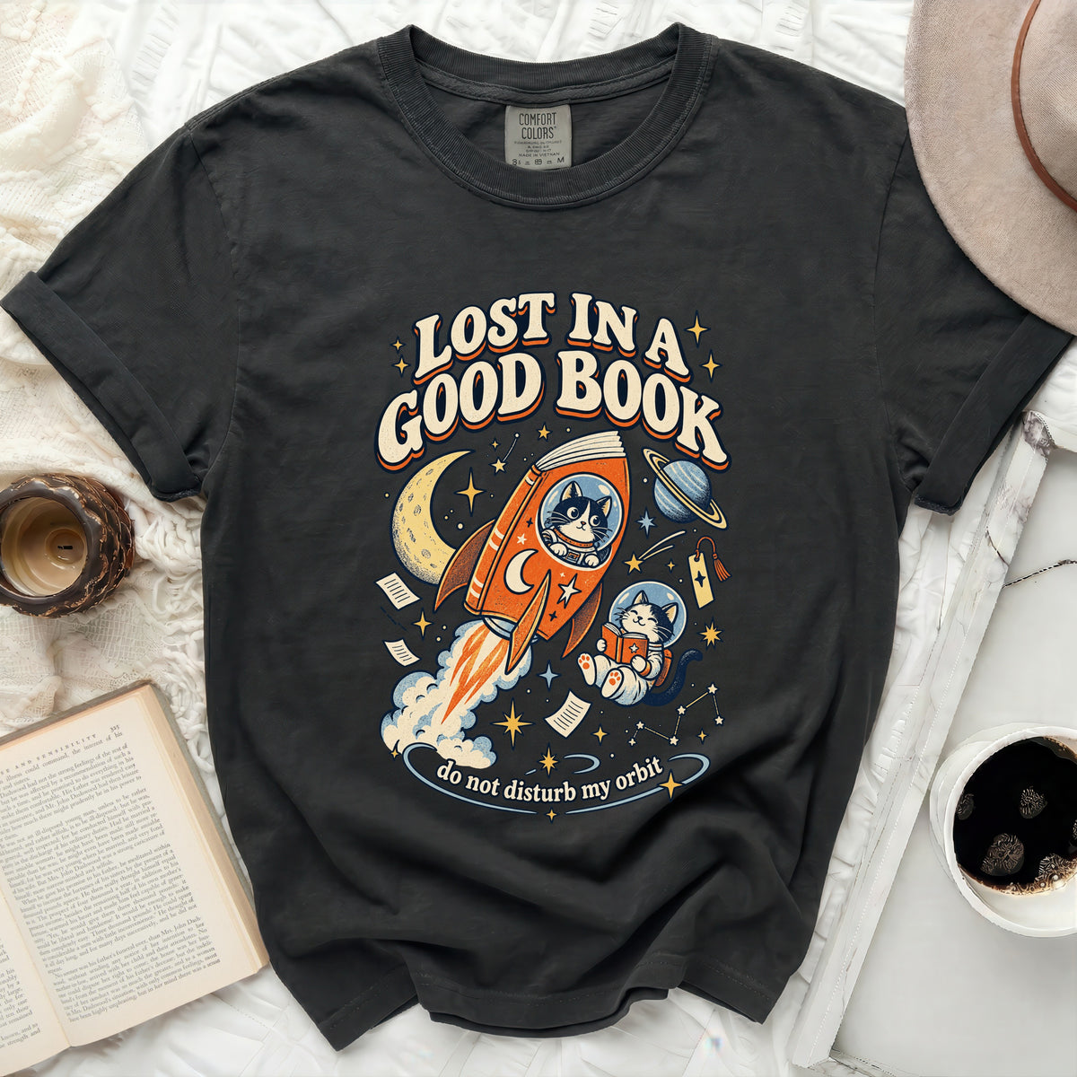 Black t-shirt with "Lost in a Good Book" text and a cat in space reading.