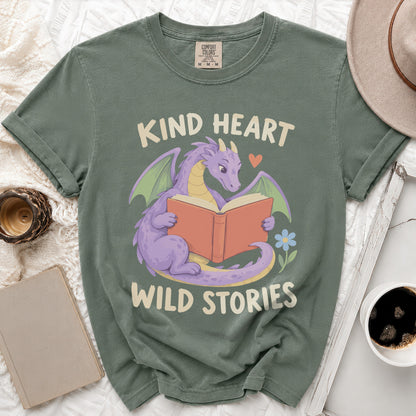 Green t-shirt with purple dragon reading book, text "Kind Heart Wild Stories".