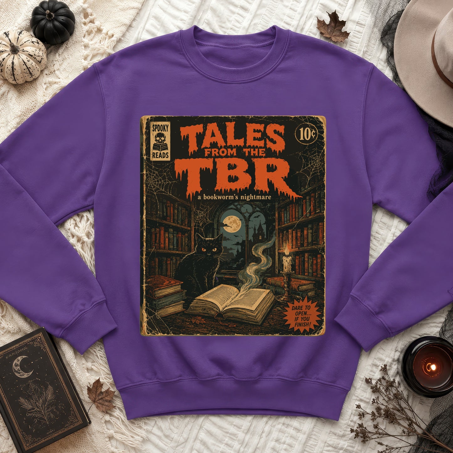 Purple sweatshirt with "Tales From The TBR" comic book graphic, featuring a black cat.