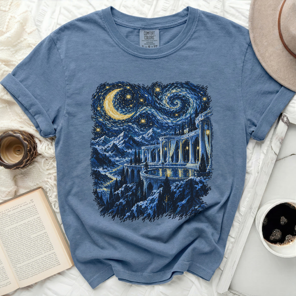 Blue t-shirt with a starry night landscape and moon print, size 6-27.