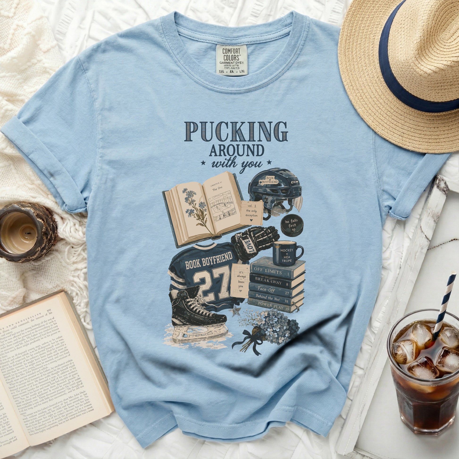 Light blue t-shirt with "Pucking Around with You" book and hockey graphics.