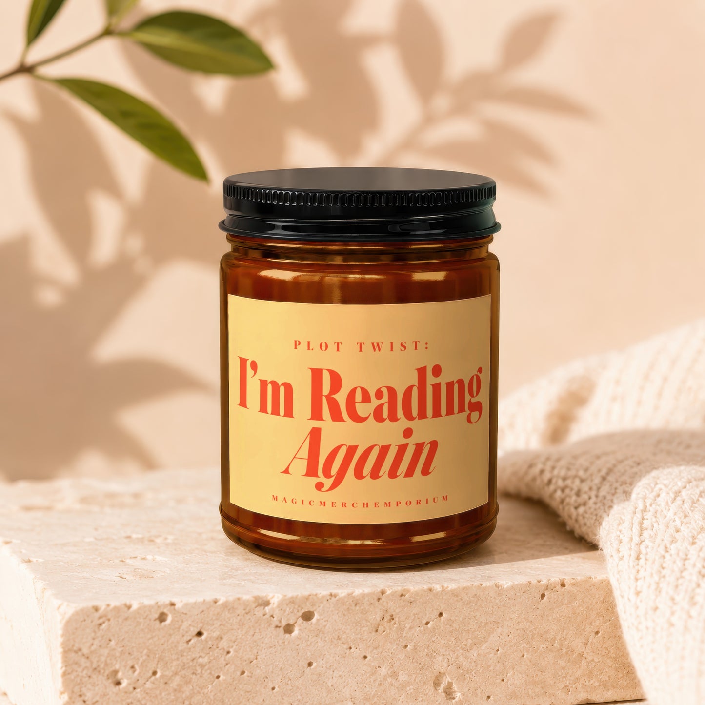 Glass jar candle with a yellow label reading "PLOT TWIST: I'm Reading Again".