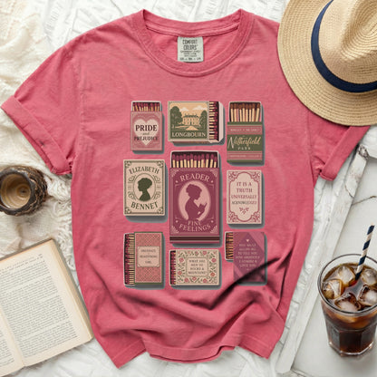 Pink t-shirt with literary-themed matchboxes: Pride and Prejudice, Longbourn, Netherfield Park, Elizabeth Bennet, Reader, Obstinate Headstrong Girl, and Jane Austen quotes.