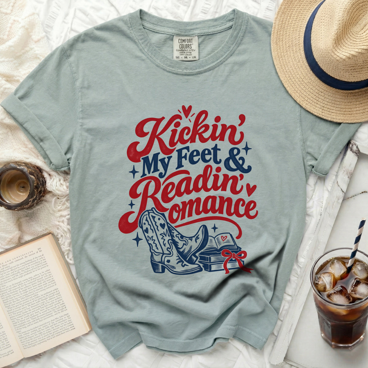 Light blue t-shirt with "Kickin' My Feet & Readin' Romance" graphic.