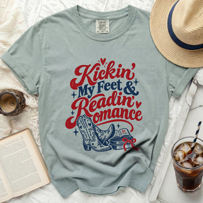 Light blue t-shirt with "Kickin' My Feet & Readin' Romance" graphic.