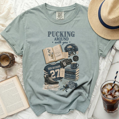 T-shirt with "Pucking Around With You" hockey and book theme.