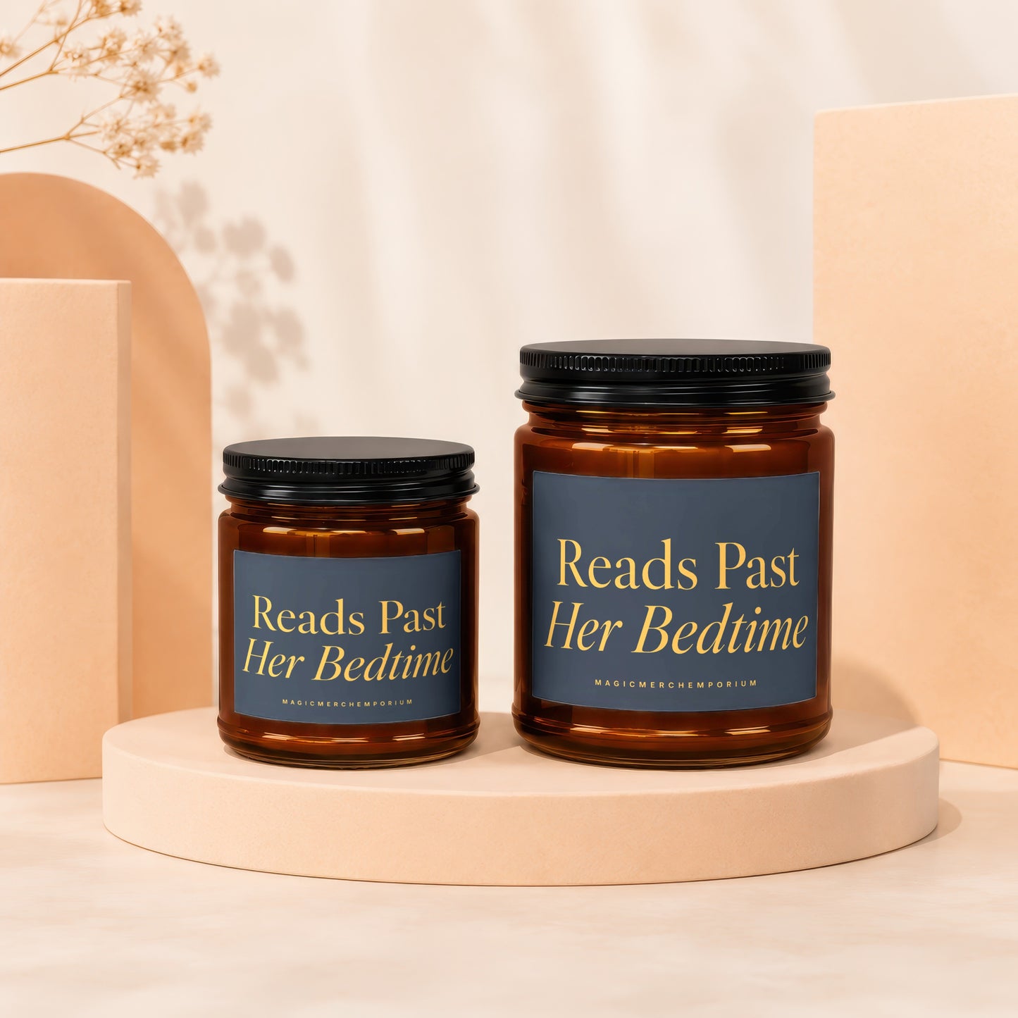 Two amber glass candles, one large and one small, labeled "Reads Past Her Bedtime".