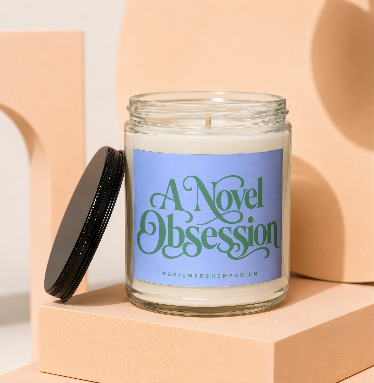 Candle with blue label reading "A Novel Obsession" and "MagicMerchEmporium"