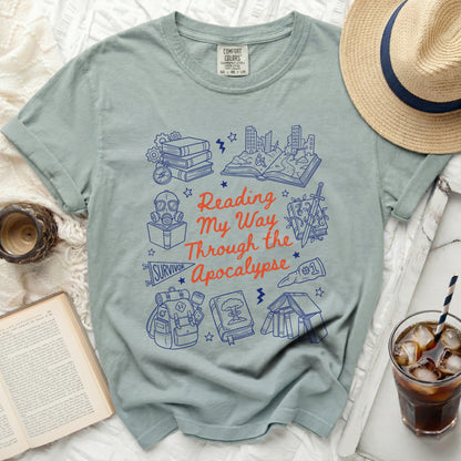 T-shirt with "Reading My Way Through the Apocalypse" text and book-themed illustrations.