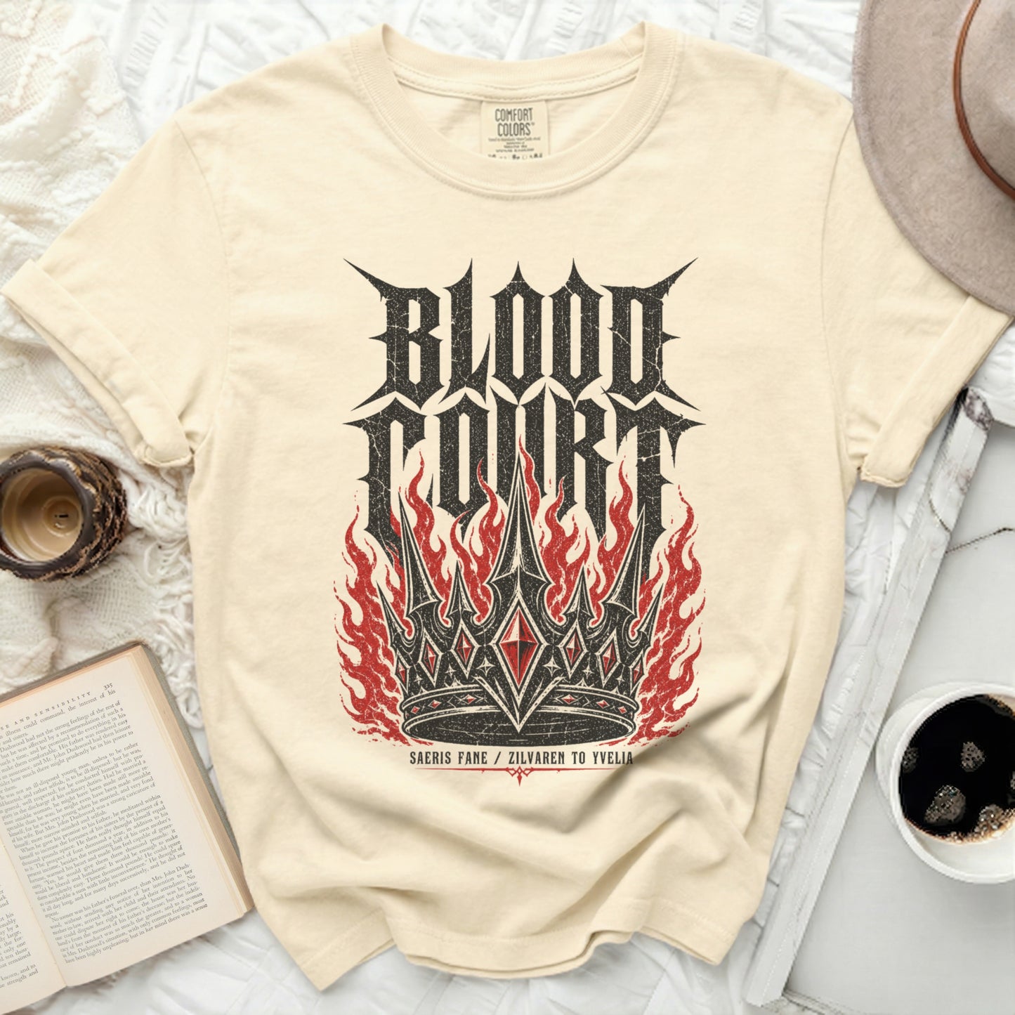 Cream t-shirt with "Blood Court" crown and flames graphic.
