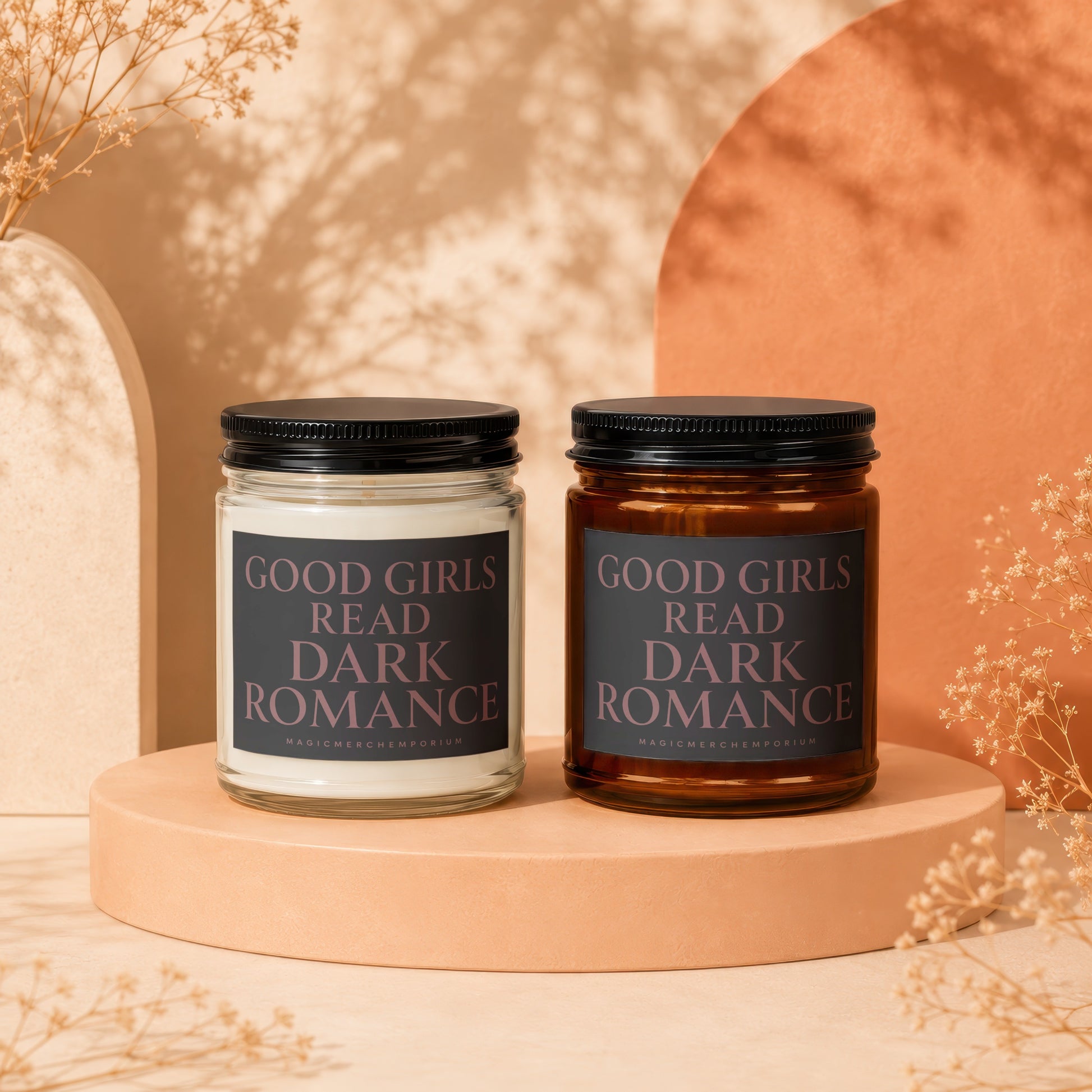 Two candles with black lids and "GOOD GIRLS READ DARK ROMANCE" labels.