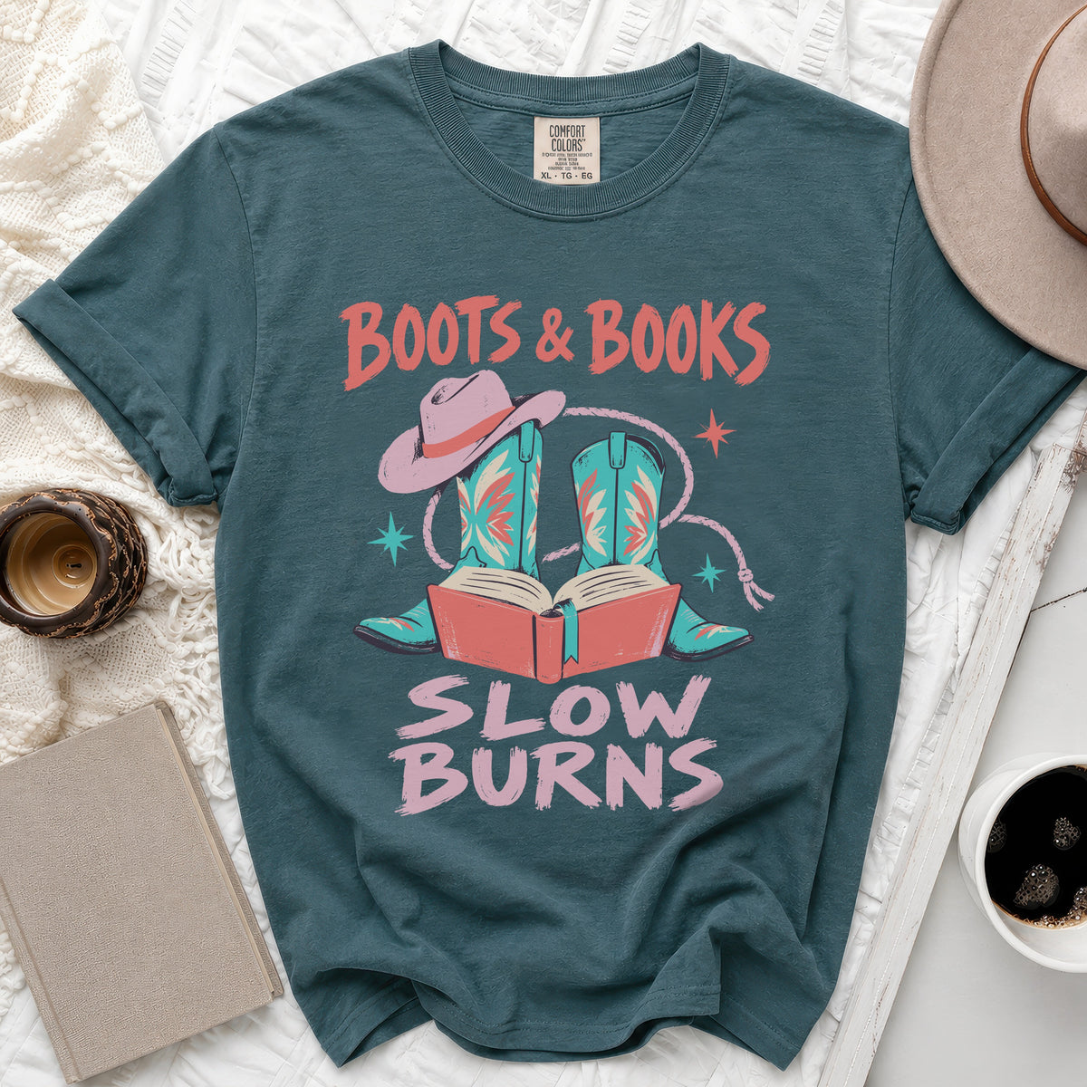 Teal t-shirt with "Boots & Books Slow Burns" and cowboy boot graphic.