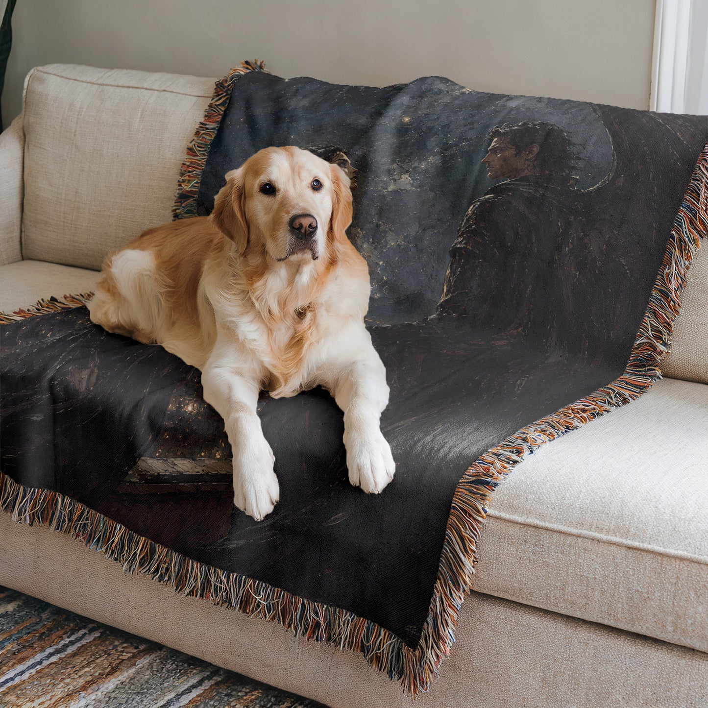 A golden retriever dog is lying on a black and brown throw blanket on a beige couch.