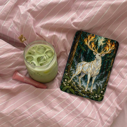 White deer with flaming antlers in a forest scene on a phone case.