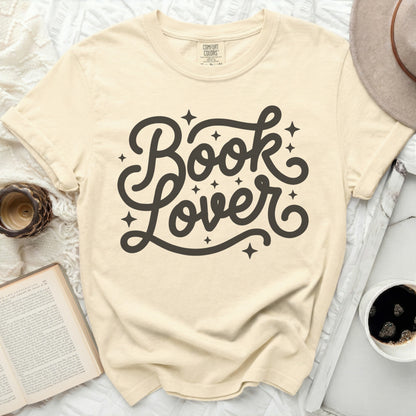 Cream t-shirt with black "Book Lover" text and star accents.